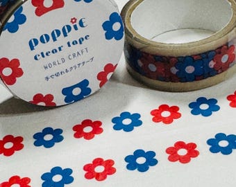 May include: Two rolls of clear adhesive tape featuring a repeating pattern of red and blue flowers. The packaging label displays the text Poppie clear tape WORLD CRAFT along with Japanese characters. The tape is unrolled to show the floral design.