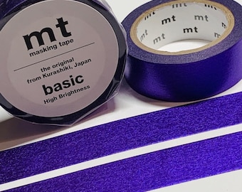 May include: Two rolls of vibrant purple masking tape. One roll is wrapped in clear plastic with a label reading mt masking tape, the original from Kurashiki, Japan, basic, High Brightness. Two strips of the same purple tape are laid out flat.