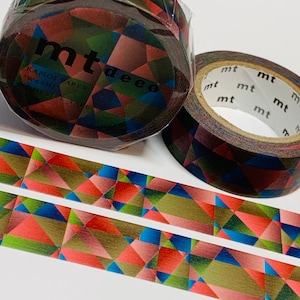 May include: Two rolls of washi tape with a geometric pattern of red, blue, green, and brown triangles. The tape is labeled "mt deco" and "Kamoi Paper Washi Adhesive Tape".