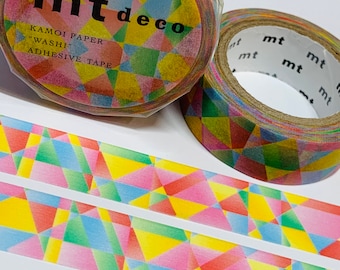 May include: Two rolls of mt deco washi tape with a colorful geometric pattern. The tape is in shades of pink, yellow, green, and blue. The packaging includes the text "mt deco" and "KAMOI PAPER 'WASHI' ADHESIVE TAPE."