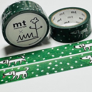 May include: Two rolls of green masking tape with white polka dots and dog illustrations. One roll is wrapped, the other is open. The tape also features the text "mt masking tape" and a line drawing.