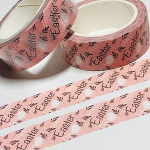 May include: Pink and white washi tape with a repeating pattern of white eggs, brown leaves, and the text "Happy Easter Day".