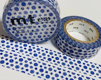 May include: Two rolls of washi tape featuring a blue floral design on a white backdrop. One roll is partially unrolled, showing the adhesive tape. The text "mt ex" is printed on the roll. Suitable for scrapbooking and crafts.