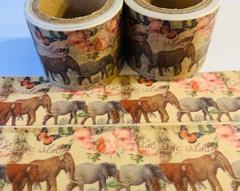 May include: Two rolls of decorative washi tape with a vintage aesthetic. The tape features a repeating pattern of elephants, roses, butterflies, and the word "wildly".
