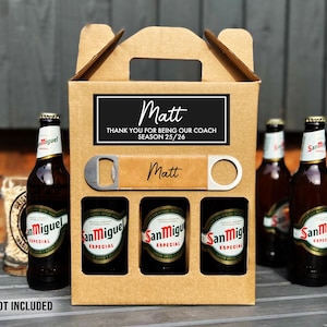 May include: A beer gift set featuring a cardboard carrier with three San Miguel Especial bottles. The carrier includes a bottle opener and a label that says "Matt, Thank you for being our coach Season 25/26."
