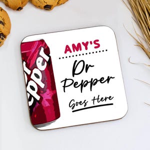 May include: Square coaster featuring a Dr Pepper can graphic and the text "AMY'S Dr Pepper Goes Here". The coaster is white with rounded corners. The image includes cookies and wheat.