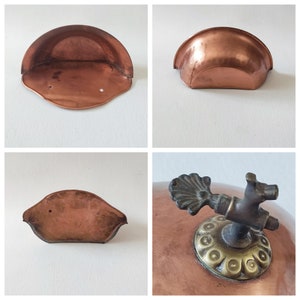 May include: Three antique copper shelf brackets with a rounded, curved shape. The brackets are made of solid copper and have a rustic, aged look.