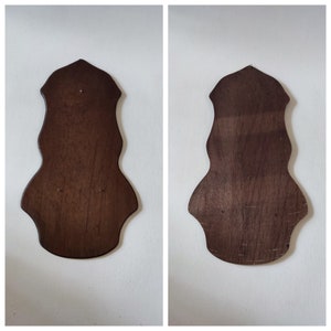 May include: Two dark brown wooden wall-mounted plaques with a scalloped edge. The plaques are blank and ready to be decorated.