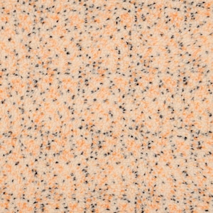 May include: Close-up of a textured fabric with a speckled pattern. The base colour is a light beige, with scattered orange and black flecks throughout. The fabric appears soft and plush, suggesting a cosy material.