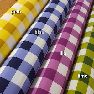 May include: Four rolls of fabric with a checkered pattern in yellow, blue, purple, and green. The fabric is labeled "gelb", "blau", "lila", and "lime".