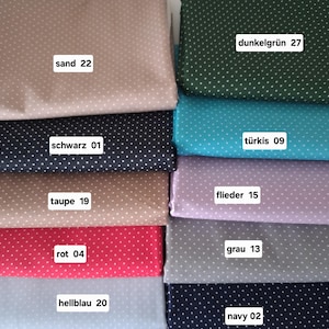 Könnte beinhalten: Ein Stapel Stoffmuster in verschiedenen Farben, darunter Sand, Dunkelgrün, Marine, Türkis und Rot. Jeder Stoff hat ein weißes Polka-Dot-Muster. Die Muster sind mit Farbbezeichnungen und Nummern versehen.
