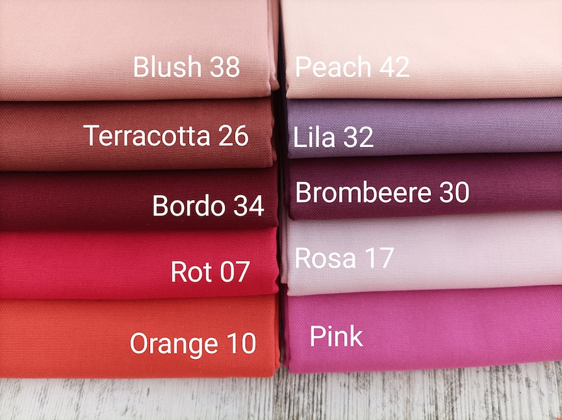 May include: A collection of fabric swatches in various colors, including blush, peach, terracotta, lila, brombeere, bordo, rosa, rot, orange, and pink. Each swatch has a color name and a number printed on it.