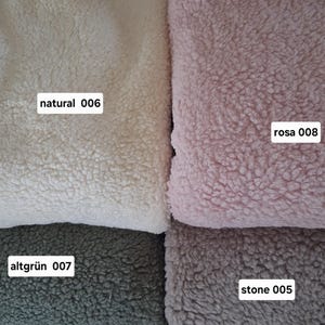 May include: Close-up of four sections of textured fabric in various colors. The colors include natural, a creamy off-white; rosa, a soft pink; altgrün, a muted green; and stone, a muted gray. Each section has a label with a color name and number.