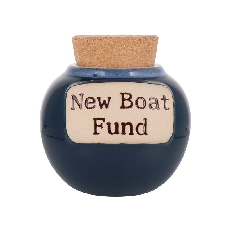 May include: A blue ceramic jar with a cork lid and a white label that reads "New Boat Fund".