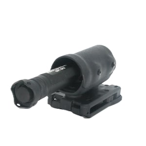 May include: A black flashlight in a black holster. The flashlight is cylindrical with a textured grip and a circular lens. The holster is mounted on a black belt clip. The image is set against a white background.