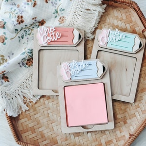May include: Three wooden pencil-shaped note holders with a sticky note pad. The holders are labeled "Mrs. Dotson", "Mrs. Guentlin", and "Mrs. Botte".