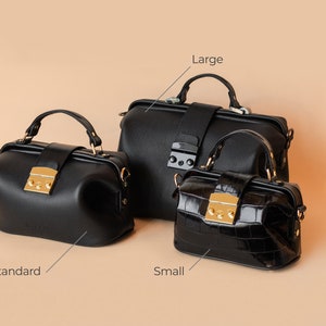 May include: Three black leather doctor bags in different sizes. The largest bag is labeled "Large", the middle bag is labeled "Standard", and the smallest bag is labeled "Small".