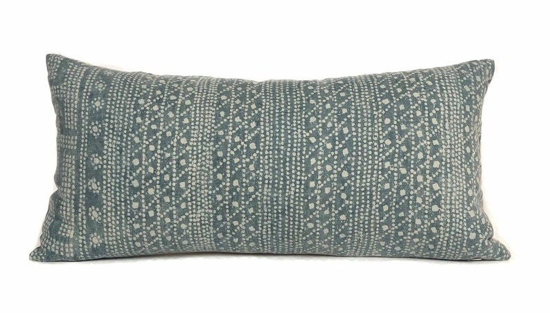 May include: A blue and white patterned lumbar pillow with a geometric design.