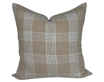 May include: A beige throw pillow with a black and white plaid pattern.