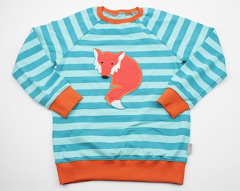 May include: A turquoise and orange striped long-sleeved sweatshirt with a red fox applique on the front.