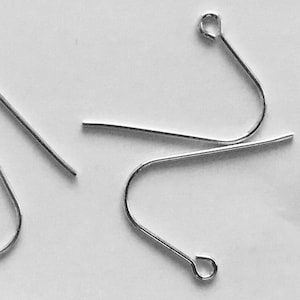 May include: Four silver earring hooks, each with a small loop at the top. The hooks are designed to be used with jewelry making.