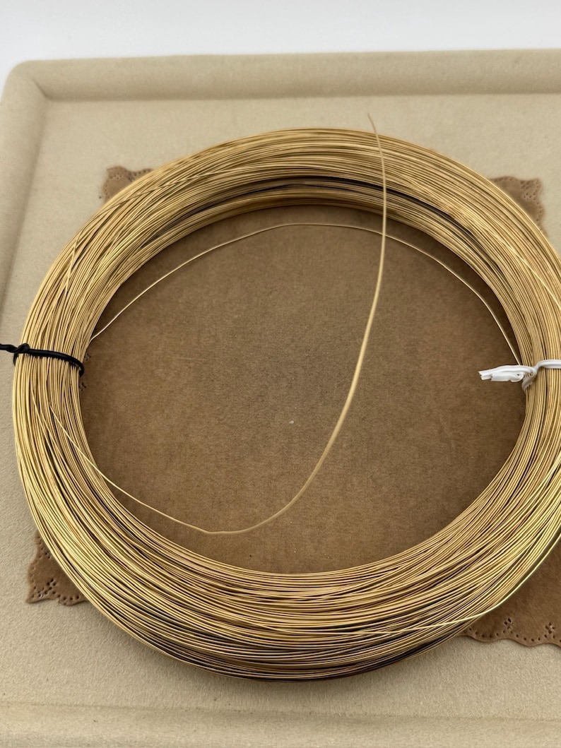 14K Yellow Gold Filled Round Wire 24 Gauge Wire Gold Filled Round Wire Soft 14/20GF 0.020th for beading and enameling sold in 60 inch lengths 
24 Gauge Wire 14K Yellow Gold Filled Round Wire sold in 5 foot length.
Soft great for pearl necklace and bracelet strands, beading, tying pig tails, fishing lures, enameling, etc…. 14/20GF 0.020 thousandths wire is semi finished just run through a jewelers cloth to polish.  5 feet weight is 2.85 grams.
for repairs, jump rings (just use a 10 Penny nail).