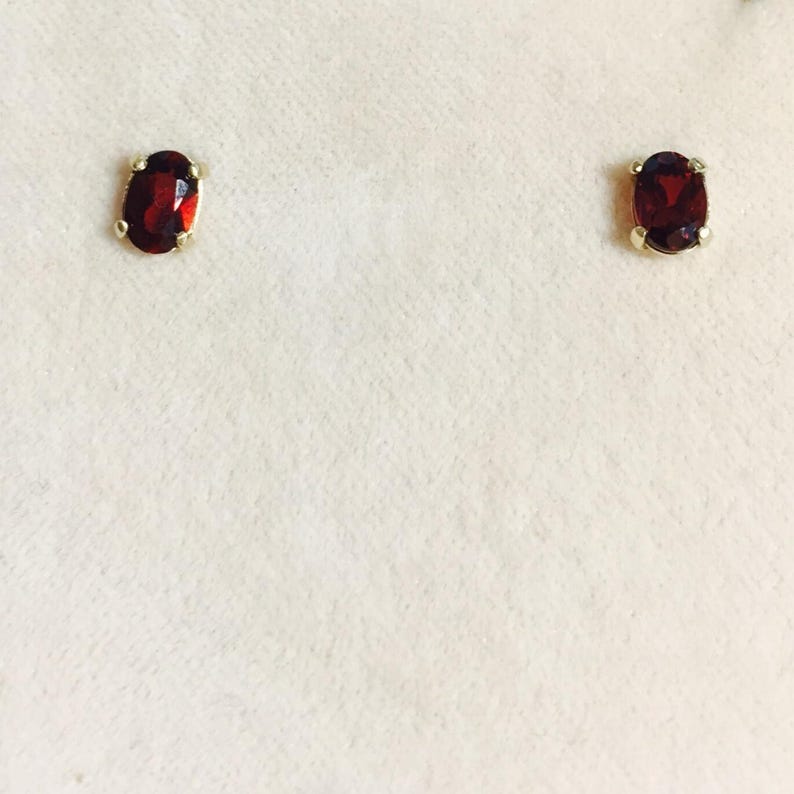 Garnet is a birthstone for the month of January. This pair of 6x4 oval Garnet earrings are set in solid 14 karat gold setting  app .95 Ct nice garnets