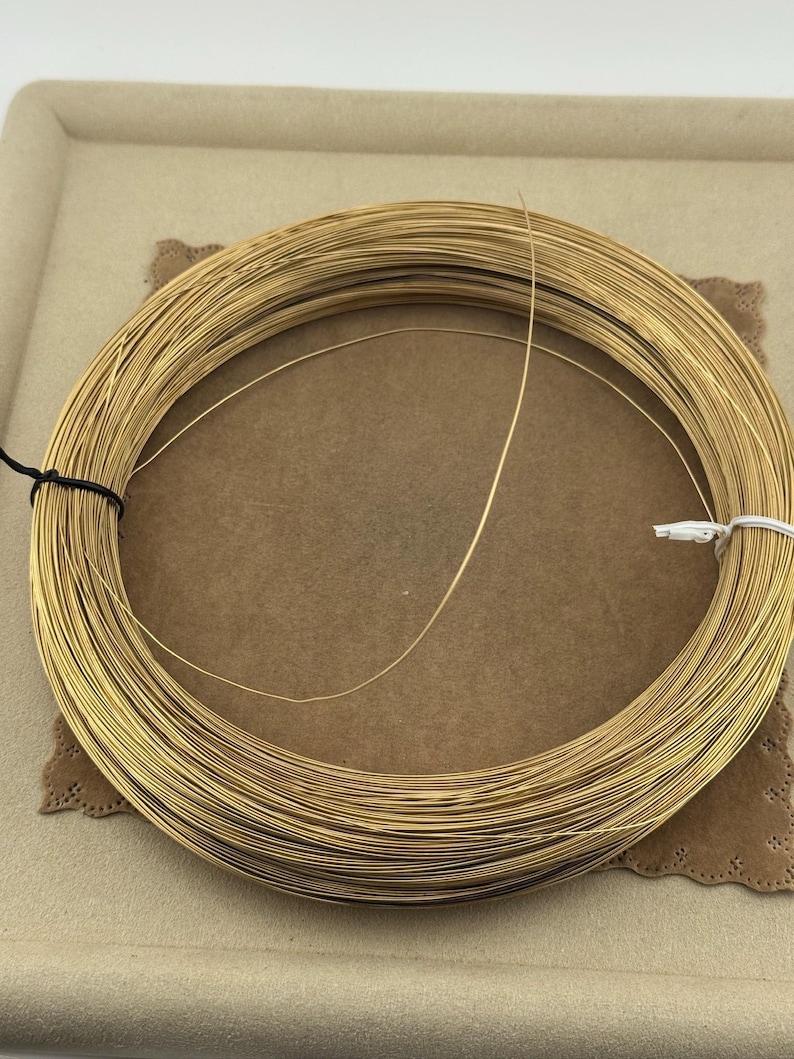 14K Yellow Gold Filled Round Wire 24 Gauge Wire Gold Filled Round Wire Soft 14/20GF 0.020th for beading and enameling sold in 60 inch lengths  24 Gauge Wire 14K Yellow Gold Filled Round Wire sold in 5 foot length. Soft great for pearl necklace and bracelet strands, beading, tying pig tails, fishing lures, enameling, etc…. 14/20GF 0.020 thousandths wire is semi finished just run through a jewelers cloth to polish.  5 feet weight is 2.85 grams. for repairs, jump rings (just use a 10 Penny nail).