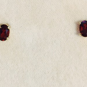 Garnet is a birthstone for the month of January. This pair of 6x4 oval Garnet earrings are set in solid 14 karat gold setting  app .95 Ct nice garnets