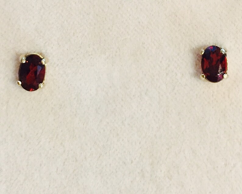 Garnet is a birthstone for the month of January. This pair of 6x4 oval Garnet earrings are set in solid 14 karat gold setting  app .95 Ct nice garnets