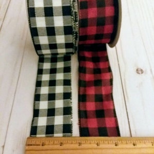 May include: Two rolls of plaid ribbon, one black and white, and one red and black. The ribbon is 2.5 inches wide.