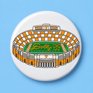 May include: A circular pin featuring an illustration of Neyland Stadium with orange and white checkered seating. The green field displays the script text Dolly and a butterfly graphic. The stadium exterior is labeled VOLS and NEYLAND STADIUM.