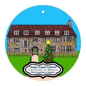 May include: A round Christmas ornament featuring a detailed illustration of a stone building with a red roof, a Christmas tree, and the text "Kappa Kappa Gamma University of Illinois Beta Lambda Chapter". The ornament has a blue sky background.