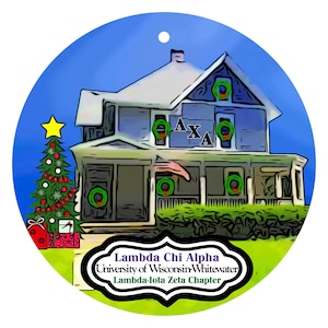 May include: A round Christmas ornament featuring a blue house decorated with green wreaths and the Greek letters ΛXA. A Christmas tree and gifts are on the left. The text "Lambda Chi Alpha University of Wisconsin-Whitewater Lambda-Iota Zeta Chapter" is at the bottom.