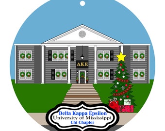 May include: A round Christmas ornament featuring a gray building with white columns and wreaths on the windows. A decorated Christmas tree with a star on top stands to the right. The ornament has the text "Delta Kappa Epsilon, University of Mississippi, Chi Chapter."