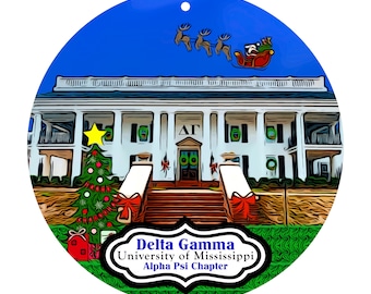 May include: A round Christmas ornament featuring a white building with columns, a Christmas tree, and Santa Claus in a sleigh. The ornament has the text "Delta Gamma University of Mississippi Alpha Psi Chapter". The background is blue.