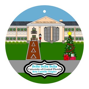 May include: A round Christmas ornament featuring a building with the text "Delta Delta Delta" above it. A Christmas tree with presents is on the right. The text "University of Central Florida Beta Lambda Chapter" is at the bottom.