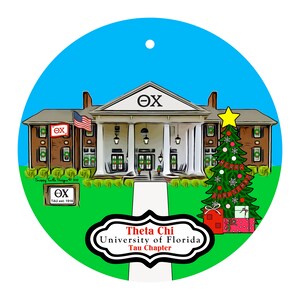 May include: A round Christmas ornament featuring a building with columns, an American flag, and a Christmas tree. The ornament has the text "Theta Chi University of Florida Tau Chapter" and the Greek letters "ΘΧ".
