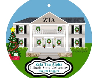 May include: A round ornament featuring a two-story house with light siding, black shutters, and a stone base. The house is decorated with green wreaths and the letters ZTA. A Christmas tree with a yellow star stands to the left. Text reads Zeta Tau Alpha Illinois State University Eta Phi Chapter.