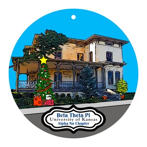 May include: A round Christmas ornament featuring a detailed illustration of a house with a decorated Christmas tree and presents. The ornament has a blue sky background and includes the text "Beta Theta Pi University of Kansas Alpha Nu Chapter."