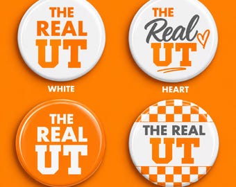 May include: Four circular pin-back buttons featuring the text THE REAL UT. One is white with orange text, one is white with gray and orange text and a heart, one is orange with white text, and one is white with a checkerboard pattern and gray text.