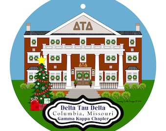 May include: A round Christmas ornament featuring a brown building with white columns and wreaths on the windows. A Christmas tree and presents are in front of the building. The text "Delta Tau Delta Columbia, Missouri Gamma Kappa Chapter" is displayed.