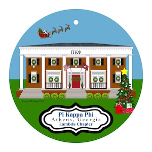 May include: A round Christmas ornament featuring a brown building with white columns and the Greek letters ΠΚΦ. Santa Claus in a sleigh pulled by reindeer flies above. The ornament includes the text "Pi Kappa Phi Athens, Georgia Lambda Chapter."