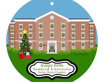 May include: A round ornament featuring a brick building with green wreaths in each window, a decorated Christmas tree with a yellow star, and red gift boxes. The text reads Kappa Delta, Samford University, Delta Theta Chapter.