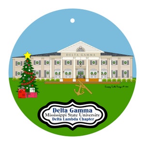 May include: A round Christmas ornament featuring a building with the text "Delta Gamma" above the entrance. A Christmas tree and presents are on the left. The ornament also includes the text "Delta Gamma Mississippi State University Delta Lambda Chapter".