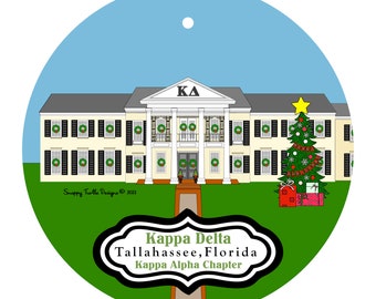 May include: A round ornament featuring a cream-colored building with a Greek letter symbol and wreaths on the windows. A decorated Christmas tree and gifts are on the lawn. The text reads "Kappa Delta Tallahassee, Florida Kappa Alpha Chapter."