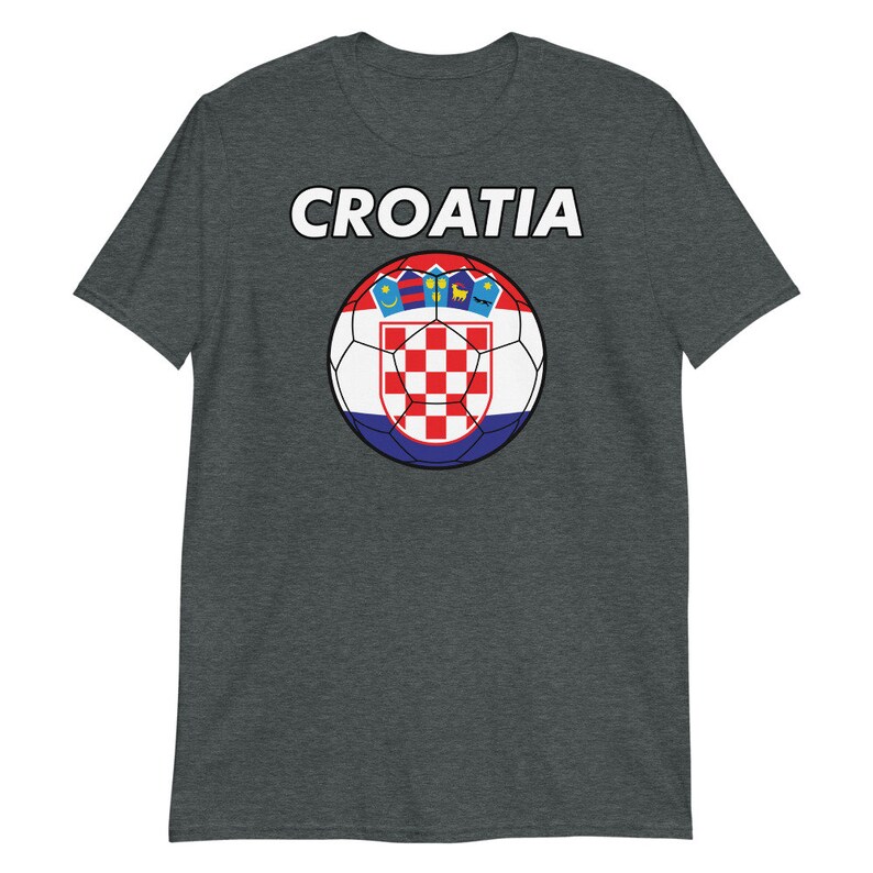 May include: Dark gray t-shirt featuring the word "CROATIA" in white block letters above a soccer ball design. The soccer ball displays the Croatian flag's red and white checkered pattern, with a blue and red border.