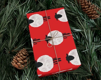 Papel de regalo navideño con ovejas, estampado de cuadros rojos y ovejas en blanco y negro