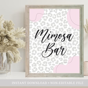 May include: A framed sign with the words "Mimosa Bar" in black script. The background features a gray leopard print pattern with pink abstract shapes. The frame is a light wood color. The words "Instant Download" and "Non-Editable File" are at the bottom.