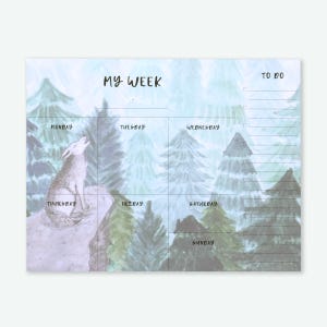May include: A weekly planner notepad with a watercolor forest scene and a howling wolf illustration. The notepad is divided into sections for each day of the week, with a "To Do" list on the top right. The words "My Week" are written at the top.
